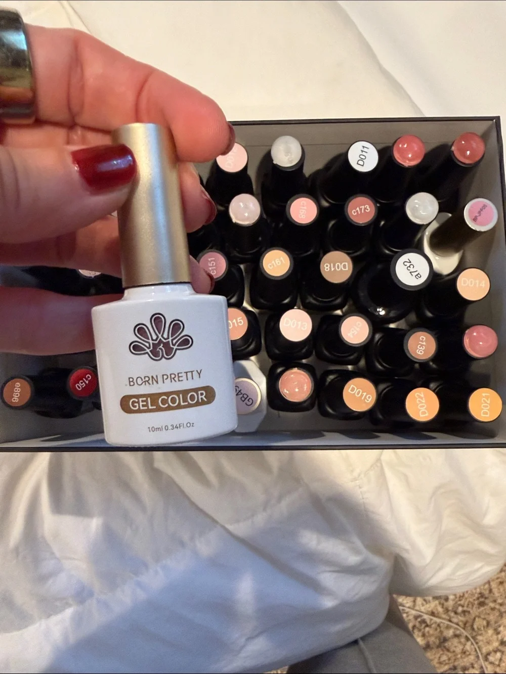 Collection of gel, nail polishes. Mostly light neutrals and dark neutrals.